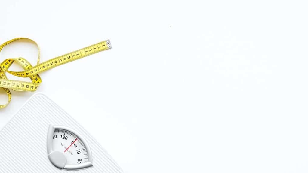 Slim concept. Scale and measuring tape on white background top view space for text