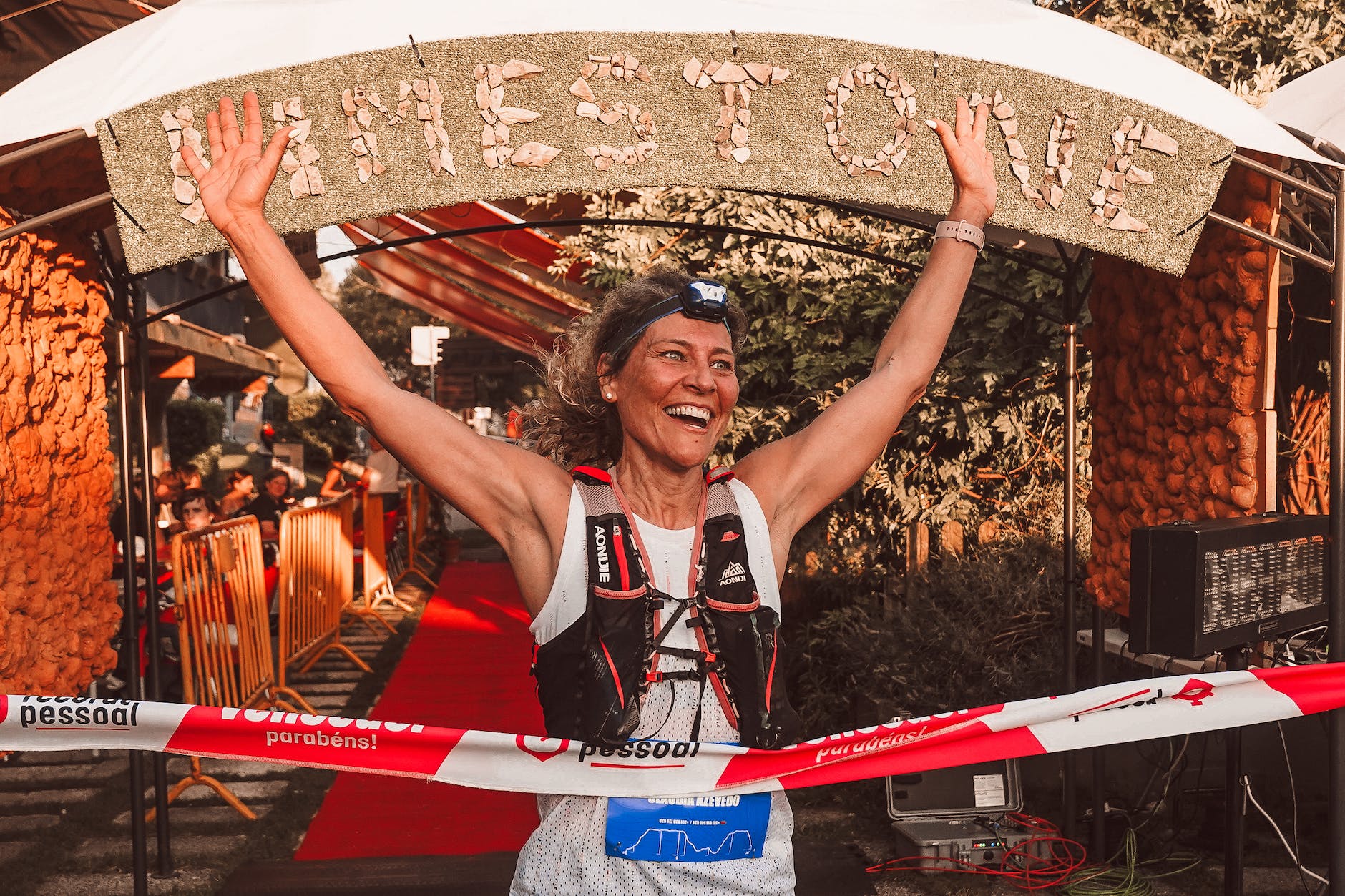 woman athlete crossing marathon finish line
