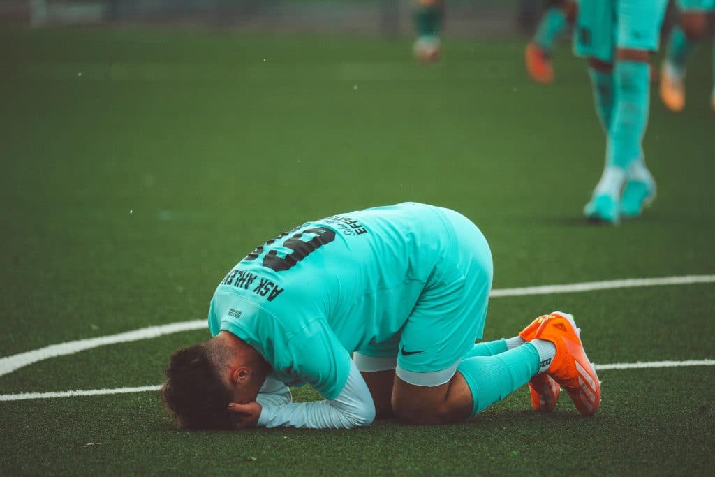 Soccer Player Despairing in Field